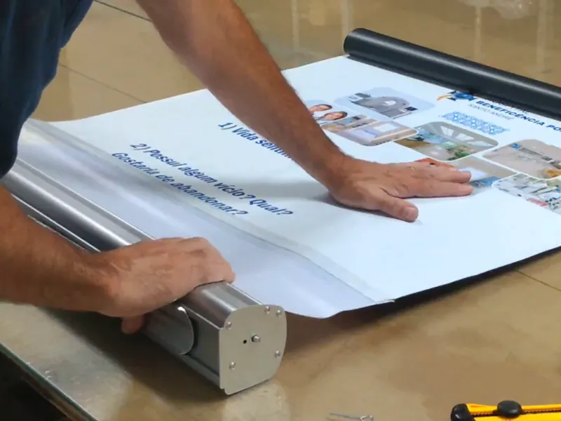 Como trocar o banner do roll up, passo 7: impressão enrolando devagar na base